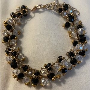 8 inch adjustable beaded bracelet with clear and black stones on a chain